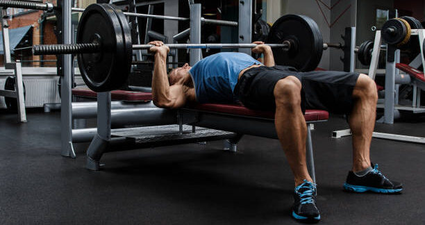 Man during bench press exercise in gym