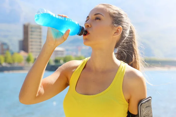 a woman drinking electrolytes