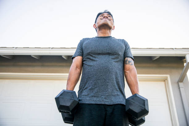 Fitness enthusiast performing dumbbell shrugs, focusing on trapezius muscles for improved upper body strength.