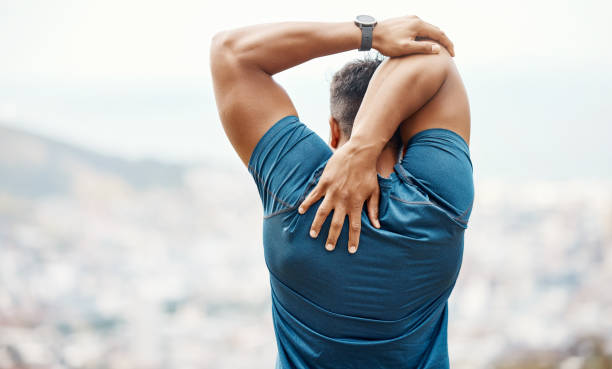 Man stretching his shoulders outdoors, highlighting the importance of flexibility in maintaining shoulder health.